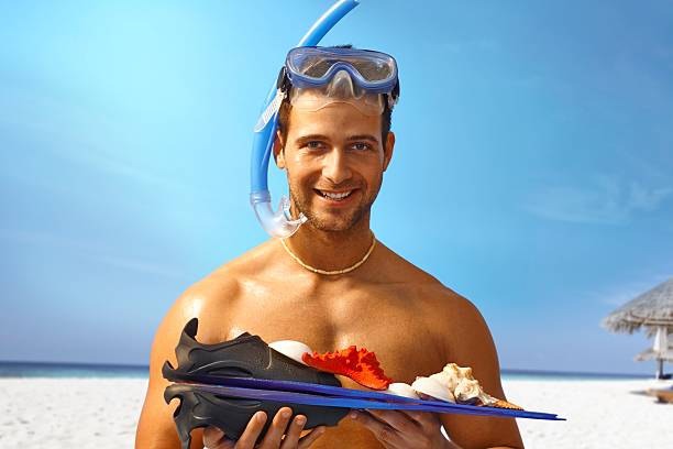 istock Happy scuba diver holding seashells 459562263