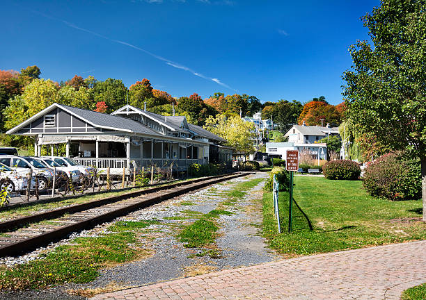 Train Station A small town train station with peak fall colors in the trees. Seen in the village of Watkins Glen New York. watkins glen stock pictures, royalty-free photos & images