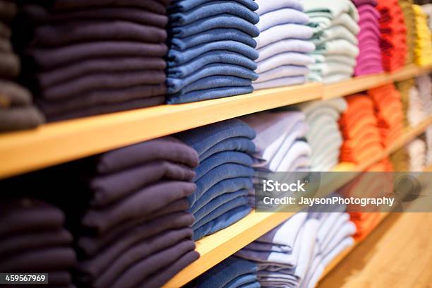 Stacks Of Different Colored Sweaters On Store Shelves Stock Photo - Download Image Now