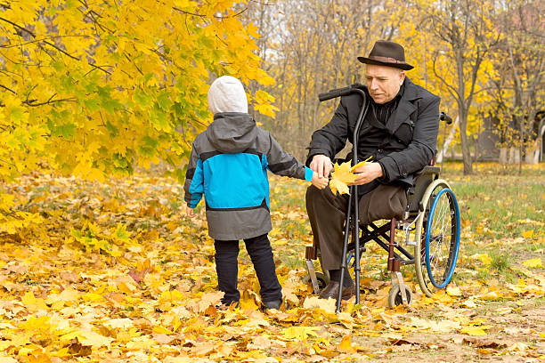 istock Little boy with his handicapped grandfather 459568539