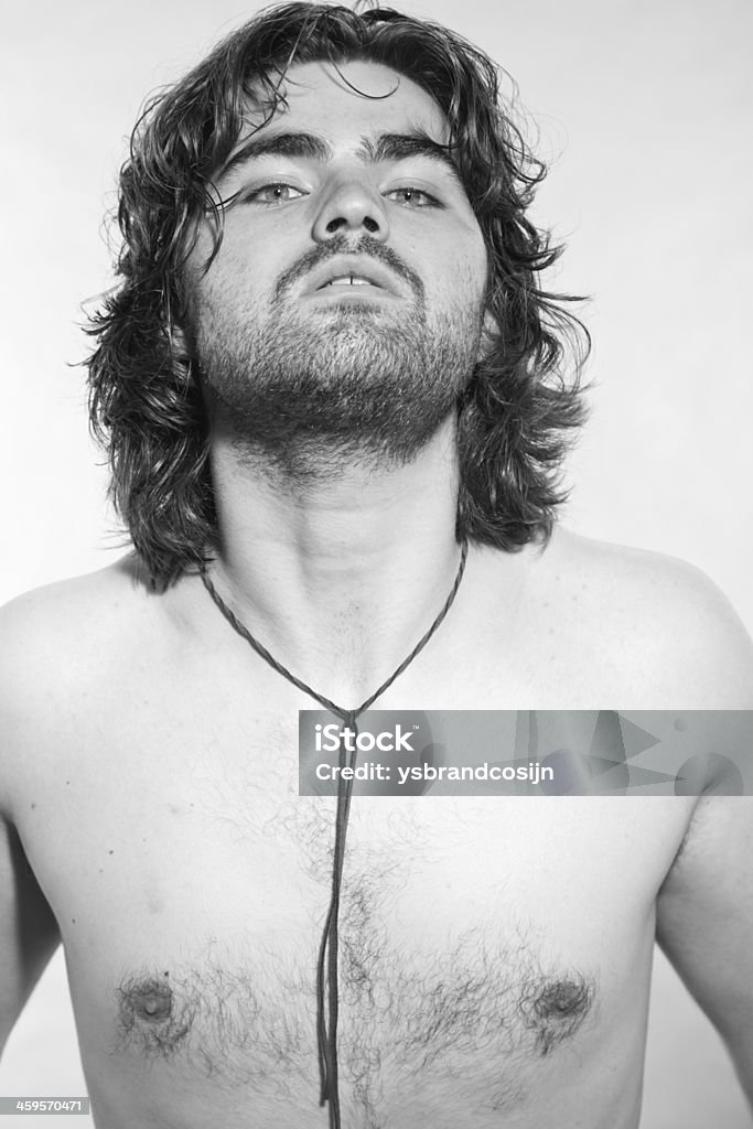 Black and white portrait of psychedelic rock style musician. Black and white portrait of psychedelic rock style musician. Rockstar performer with arrogant looks. Adult Stock Photo