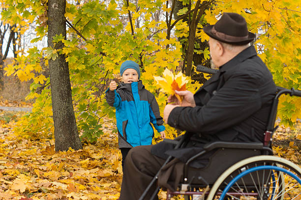 istock Elderly disabled man playing with his grandson 459570775