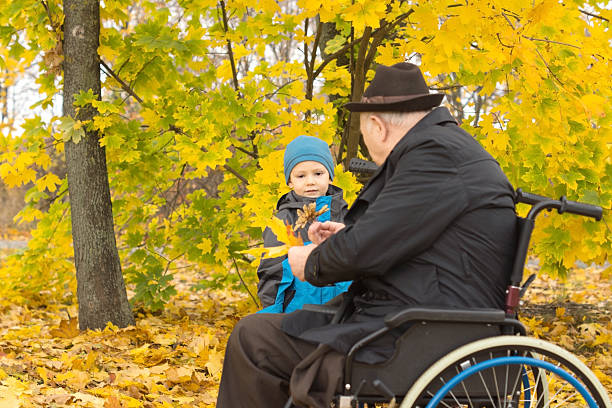istock Little boy with his handicapped grandfather 459570777