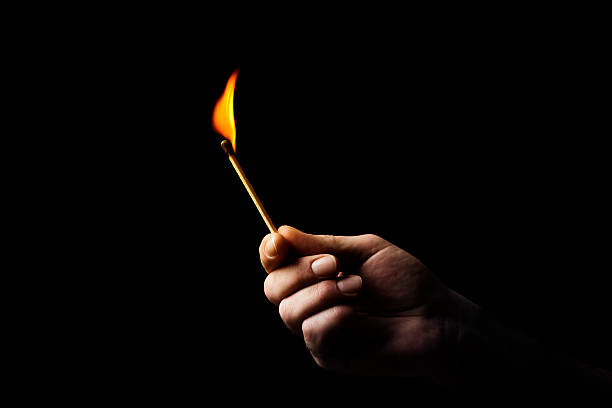 Match Male hand with burning match lit match stock pictures, royalty-free photos & images