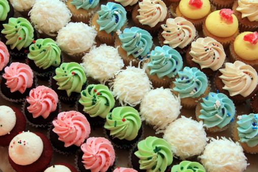 Tray of colorful mini cupcakes, also available in vertical.