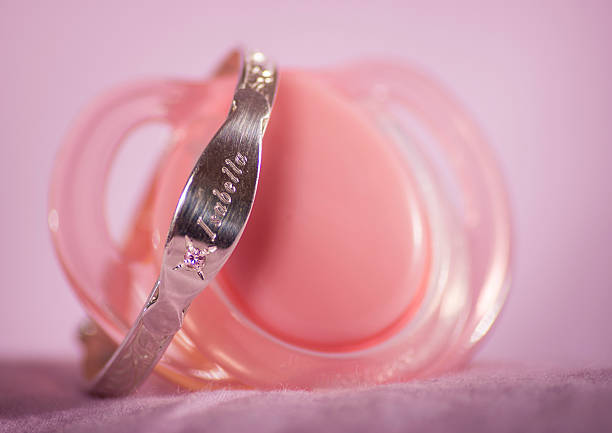 Dummy This is a babys bangle on a pink dummy baby bracelet stock pictures, royalty-free photos & images