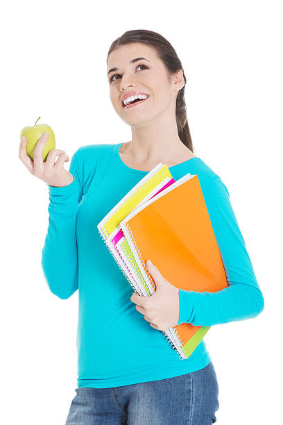 istock Beautiful young student with files and apple. 459593899
