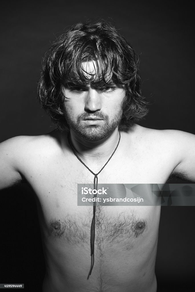 Black and white portrait of psychedelic rock style musician. Roc Black and white portrait of psychedelic rock style musician. Rockstar performer with arrogant looks. Adult Stock Photo