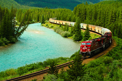 Banff National Park, Alberta, Canada - 18 July 2008: A Canadian Pacific train traveling on railroad tracks along the Bow River.