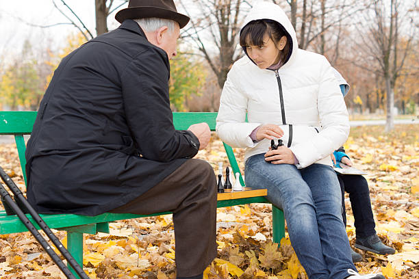 istock Two friends playing chess in the park 459596583
