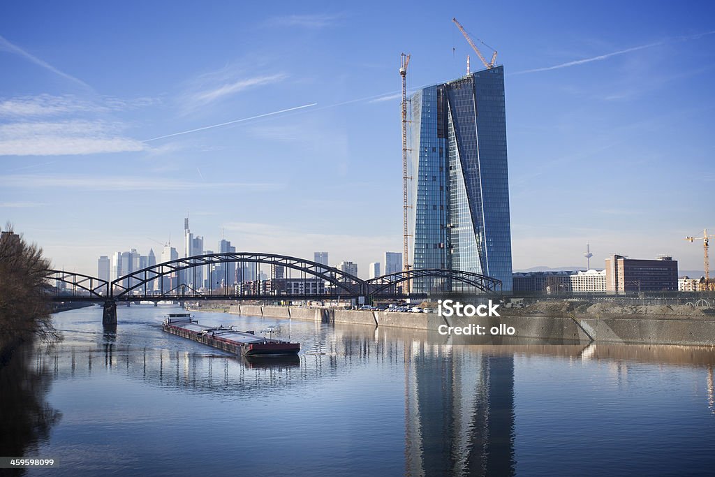 Cargo ship and ECB, European Central Bank Frankfurt Cargo ship on River Main. In the backgrounf ECB, European Central Bank Frankfurt - construction site and Deutschherrenbruecke (railway bridge), December 2013. European Central Bank Stock Photo