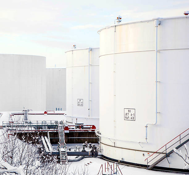 istock white tanks in tank farm with snow 459615891