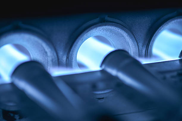 Home Furnace Burner Blower Ignited Closeup Shot Of Home Furnace Burner Ignited flange stock pictures, royalty-free photos & images