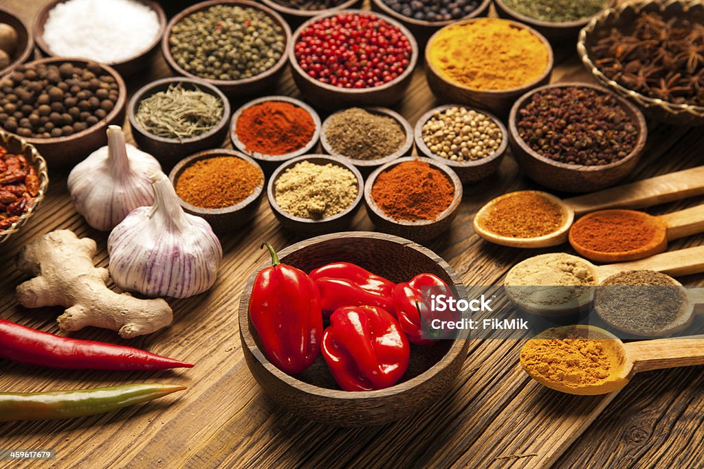Selection of spices Selection of various colorful spices on a wooden table in bowls Bowl Stock Photo