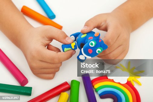 istock Child creating a blue clay sculpture  459631397