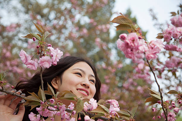 istock Serene young woman by beautiful pink blossoms 459643731