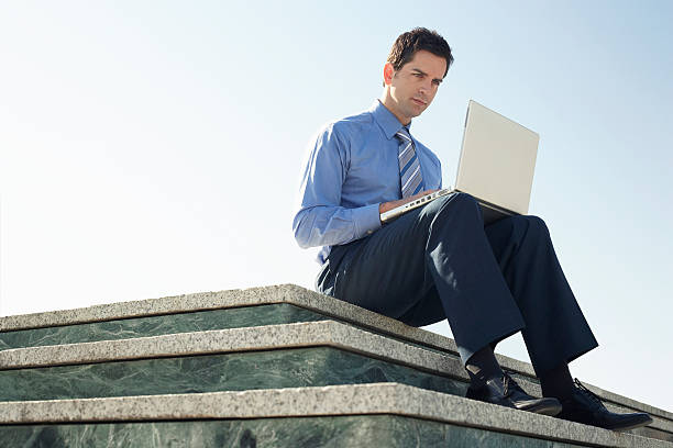 istock Businessman Using Laptop On Marble Staircase 459649591