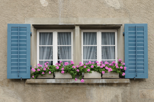 A typical switzerland window with louvered shuters and square