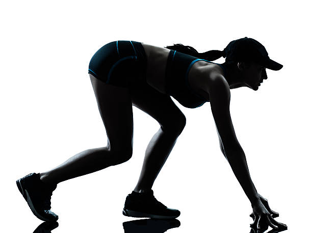 istock woman runner jogger on the starting block silhouette 459668989