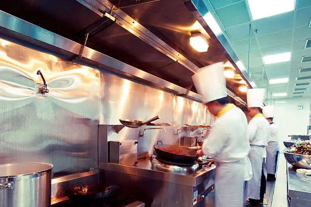 Photo of motion chefs of a restaurant kitchen