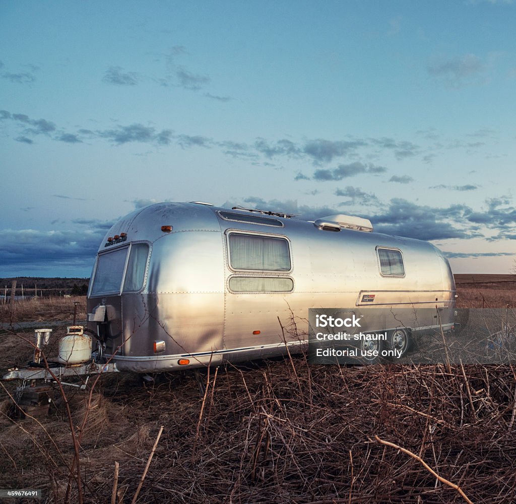 Airstream Travel Trailer Brookvale, Canada - April 17, 2013: An Airstream International Overlander travel trailer parked in a field along a rural backroad. Airstream - Brand Stock Photo