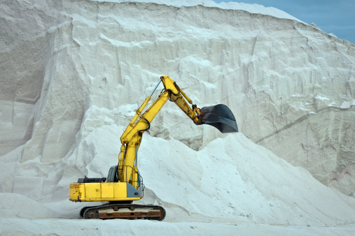 Big machine digging sea salt, Puglia, Italy, Europe.