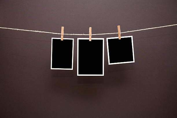 istock blank old photos hanging from clothesline 459712573