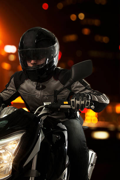 istock Young Man riding a motorcycle at night 459730569
