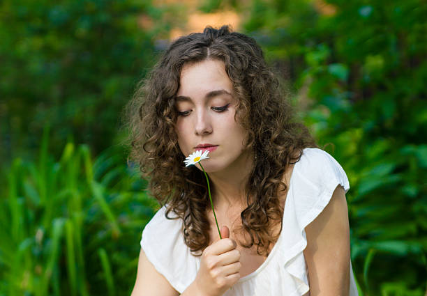 istock Beautiful romantic woman with daisy flower 459732305