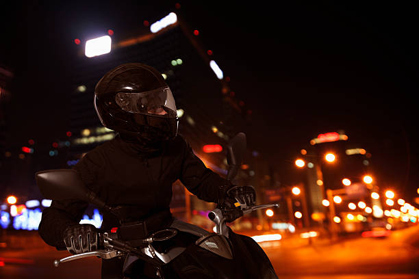 istock Adventurous young man riding his motorcycle during the night 459856053