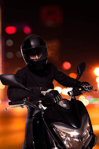 istock Young man sitting on his motorcycle at night in Beijing 459856055