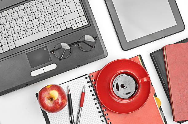 istock Laptop and office supplies on white 459858737
