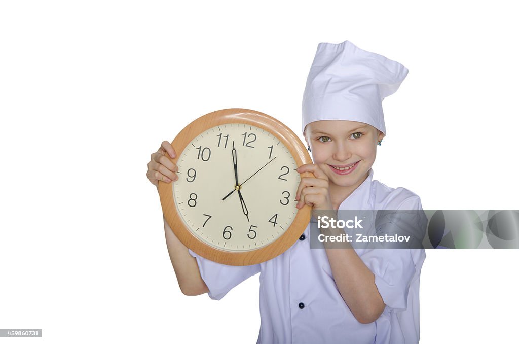 Girl chef smiling with clock Girl chef smiling with clock isolated on white Activity Stock Photo