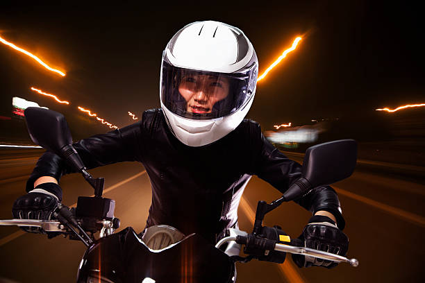 istock Young woman riding a motorcycle 459861629
