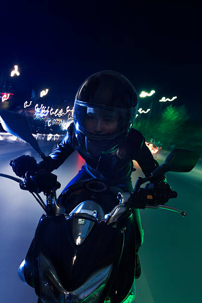 istock Young woman riding a motorcycle 459861651