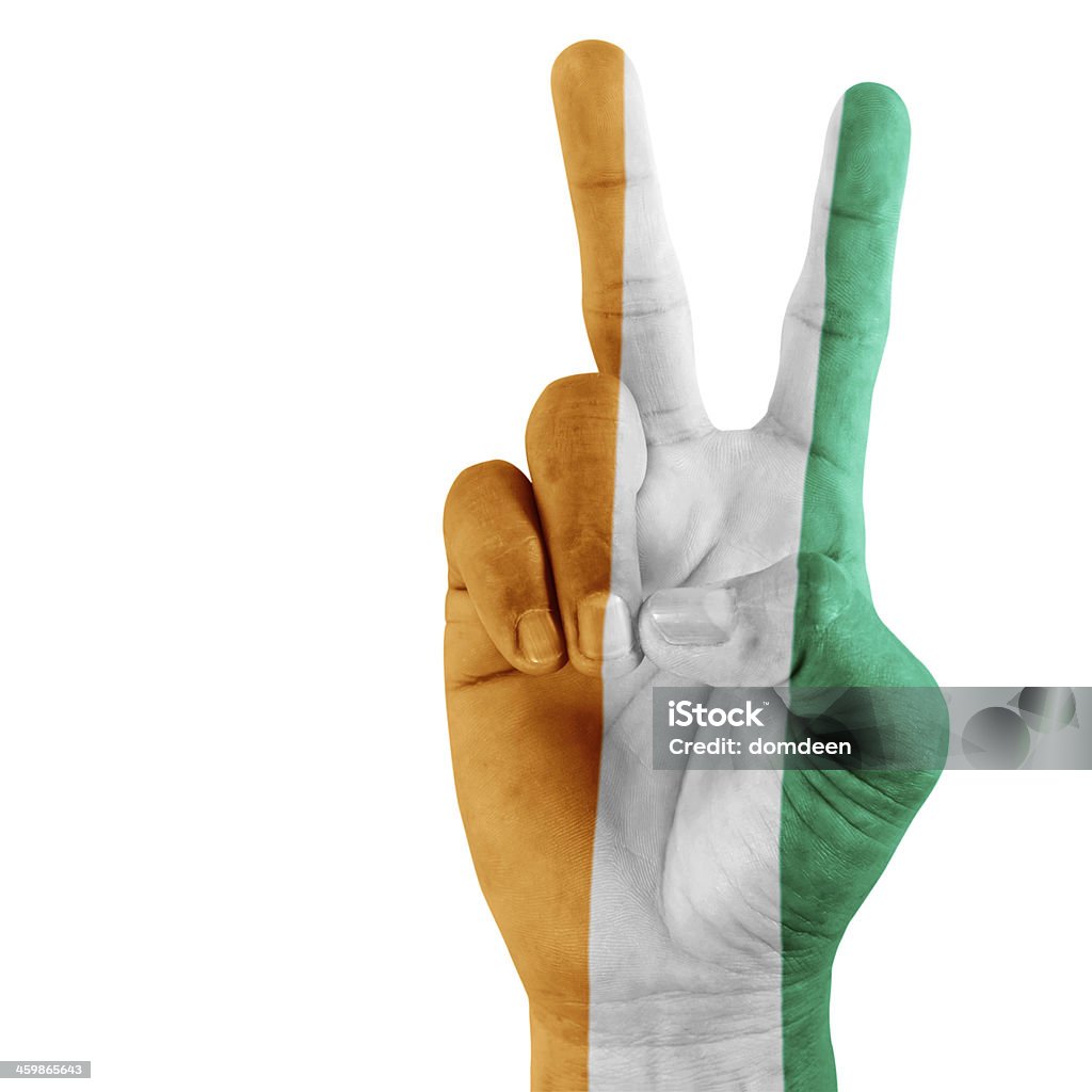 Flag Of Ivory Coast  On Victory Hand Flag Of Ivory Coast on victory hand with a white background. Achievement Stock Photo