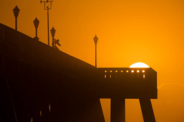 istock Sunrise Peaks Over Top End Silhouetted Pier 459870965
