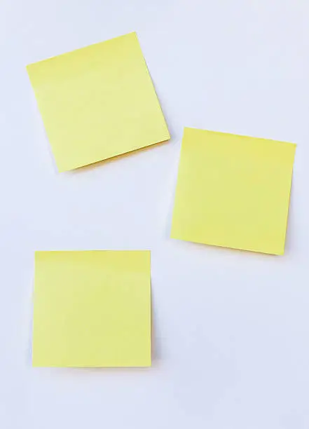 Photo of blank yellow note on isolated white background