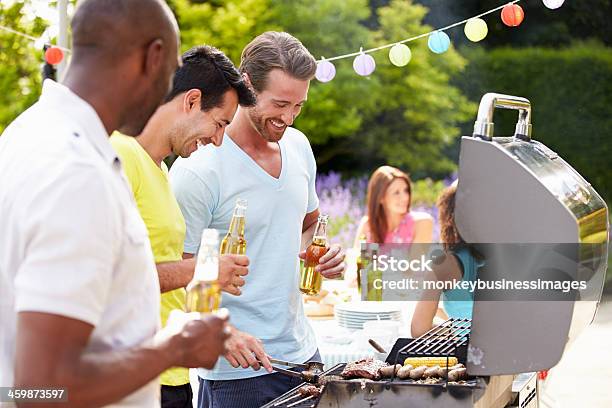 Group Of Men Cooking On Barbeque At Home Stock Photo - Download Image Now - 20-29 Years, 30-39 Years, Adult