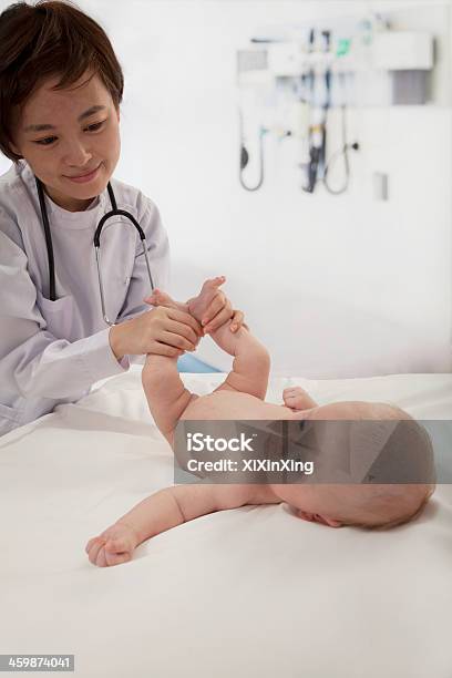 Smiling Doctor Examining A Baby In The Doctors Office Stock Photo - Download Image Now