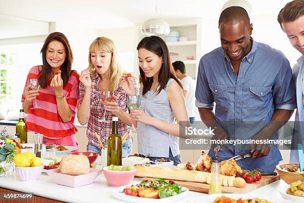 Group Of Friends Having Dinner Party At Home Stock Photo - Download Image Now - 20-29 Years, 30-39 Years, Adult