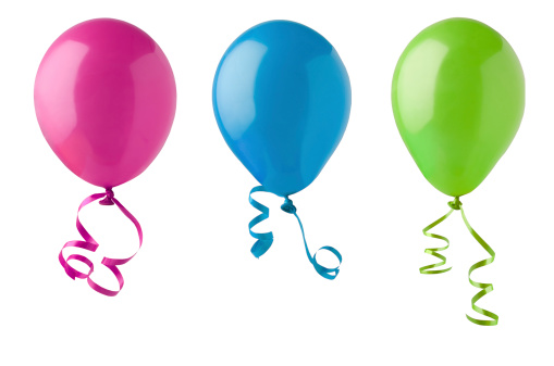 Three party balloons in bright colours of pink, blue and green, tied with twirling ribbon streamers and isolated on a white a background.