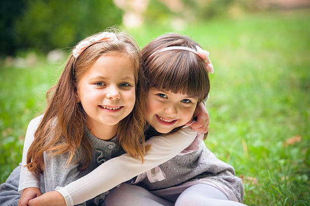 istock Happy little girlfriends in park 459876035
