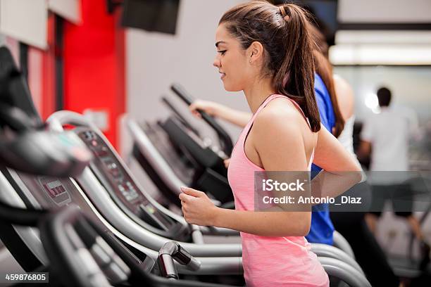 Beautiful Brunette On A Treadmill Stock Photo - Download Image Now - 20-29 Years, Activity, Adult