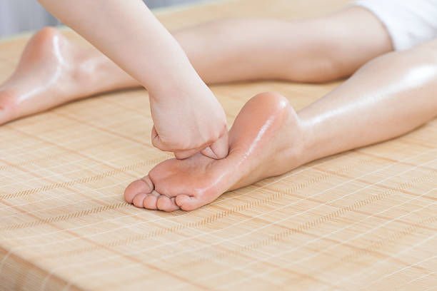 istock Young woman has foot massage 459878255