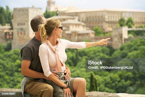 Happy Tourist Couple With Woman Pointing At View Stock Photo - Download Image Now - Adult, Architecture, Enjoyment