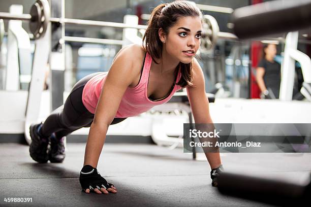 Cute Brunette Working Out At A Gym Stock Photo - Download Image Now - Gym, Health Club, Women