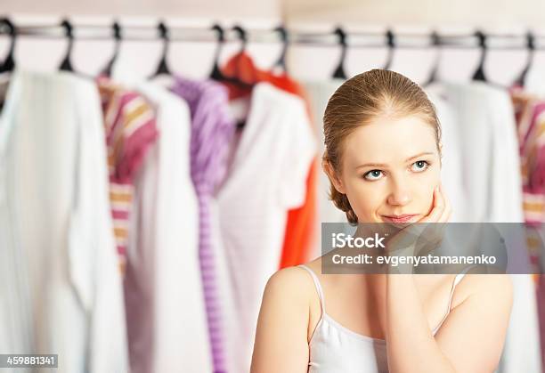 Woman Chooses Clothes In The Wardrobe Closet At Home Stock Photo - Download Image Now