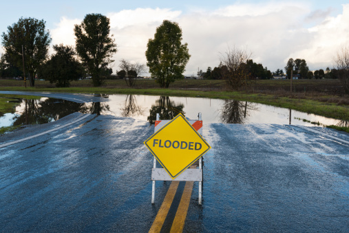 Flooded warning sign on an impassable road, San Martin, California