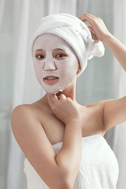 istock Woman doing facial mask 459885501